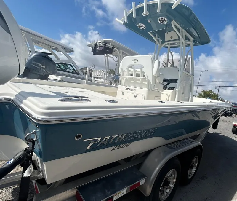 Slide: The Image of 2025 Pathfinder 2600 TRS boat on trailer, featuring Yamaha engine, under clear blue sky. - 7
