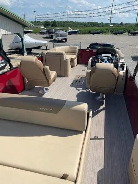 Slide: The Image of 2023 Veranda VR22VLC pontoon boat with beige seating and modern dashboard. - 3