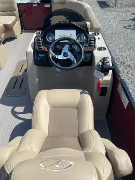 Slide: The Image of 2023 Veranda VR22VLC boat interior with steering wheel and Garmin navigation system. - 5