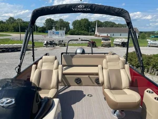 Slide: The Image of 2023 Veranda VR22VLC pontoon boat with beige seating and canopy, parked outdoors. - 7