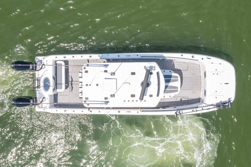 Slide: The Image of 2024 Invincible 33 Catamaran, aerial view, cruising on green water. - 1