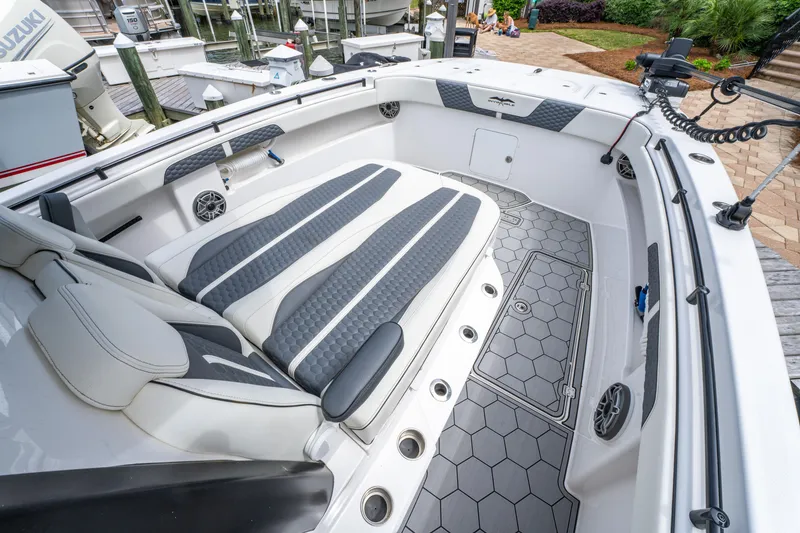 Slide: The Image of 2024 Invincible 33 Catamaran interior with cushioned seating and hexagonal flooring design. - 12
