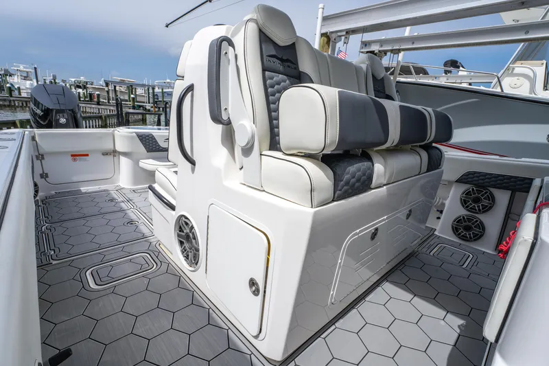 Slide: The Image of 2024 Invincible 33 Catamaran interior with cushioned seating and hexagonal flooring. - 16