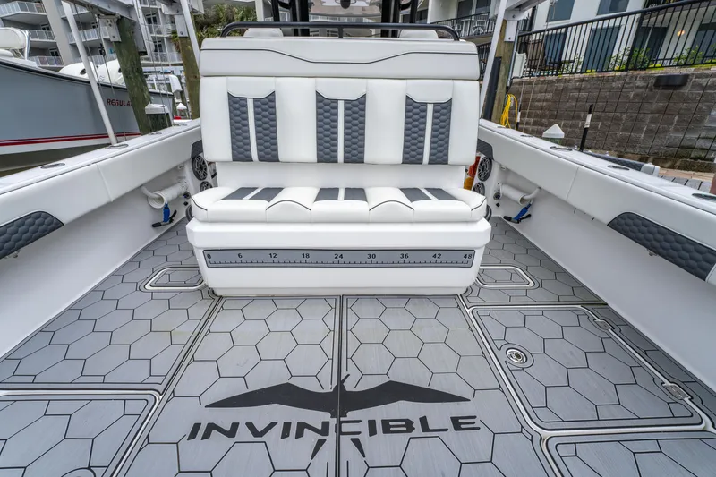 Slide: The Image of 2024 Invincible 33 Catamaran interior with stylish seating and hexagonal patterned flooring. - 17