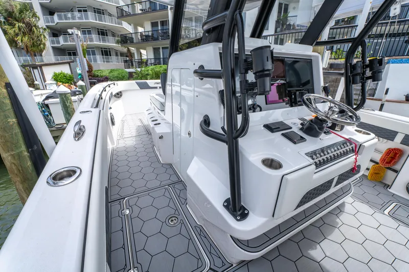 Slide: The Image of 2024 Invincible 33 Catamaran with modern helm, sleek design, and spacious deck. - 19