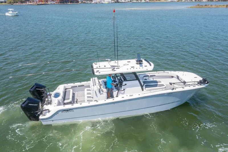 Slide: The Image of 2024 Invincible 33 Catamaran on water, featuring dual engines and spacious deck. - 2