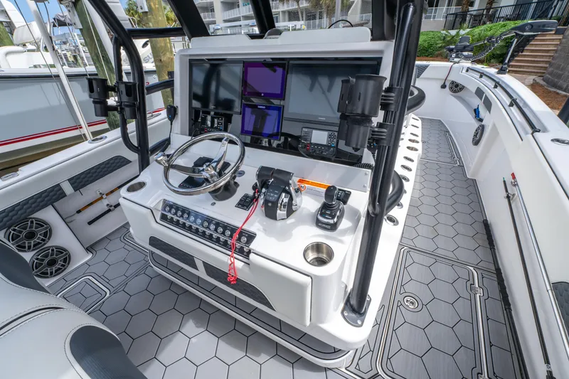 Slide: The Image of 2024 Invincible 33 Catamaran cockpit with advanced navigation and control systems. - 20