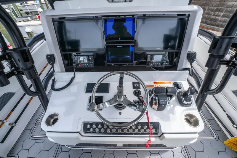 Slide: The Image of 2024 Invincible 33 Catamaran helm with advanced navigation and control systems. - 21