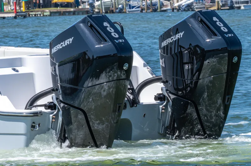 Slide: The Image of 2024 Invincible 33 Catamaran with dual Mercury 400 outboard engines in water. - 24