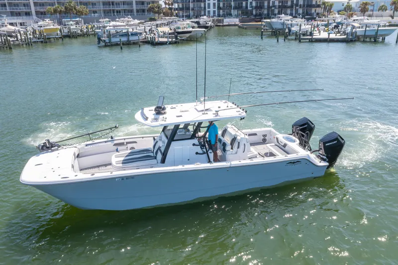 Slide: The Image of 2024 Invincible 33 Catamaran cruising in a marina with modern design and twin engines. - 3