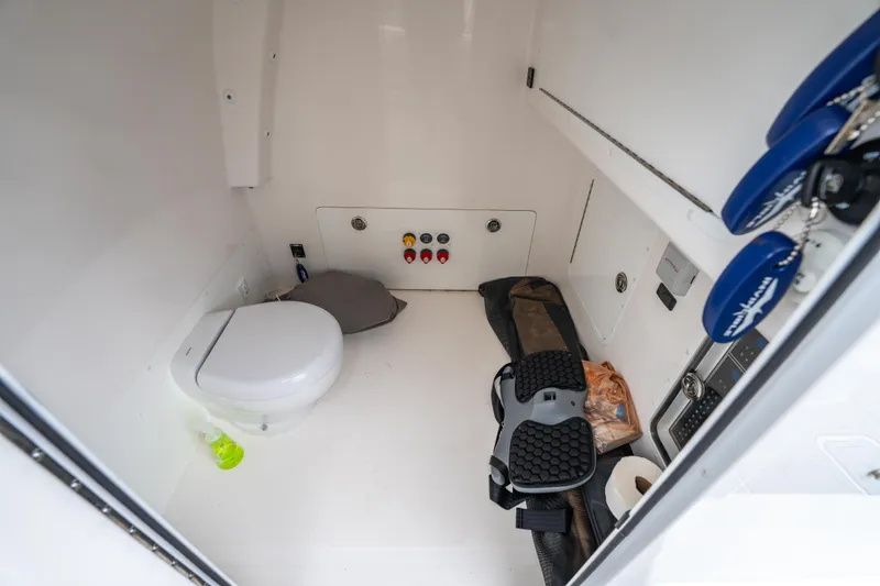 Slide: The Image of 2024 Invincible 33 Catamaran interior with toilet and storage space. - 35