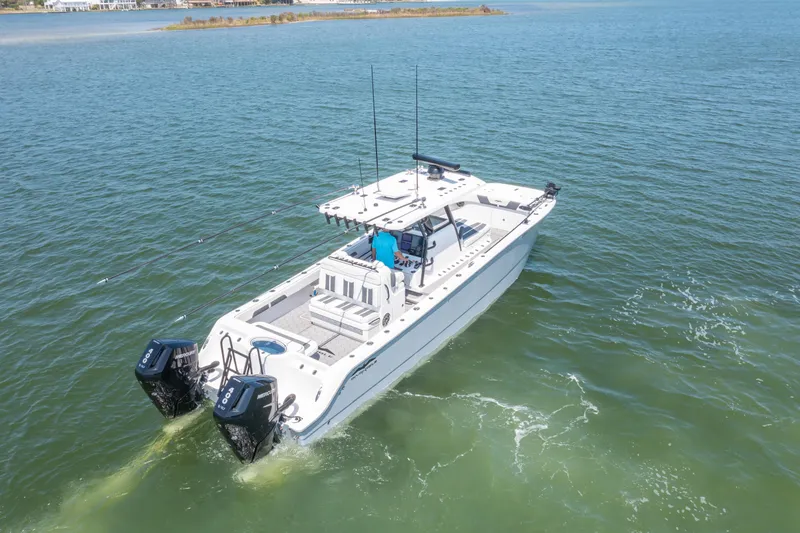 Slide: The Image of 2024 Invincible 33 Catamaran cruising on open water, featuring dual outboard engines. - 4