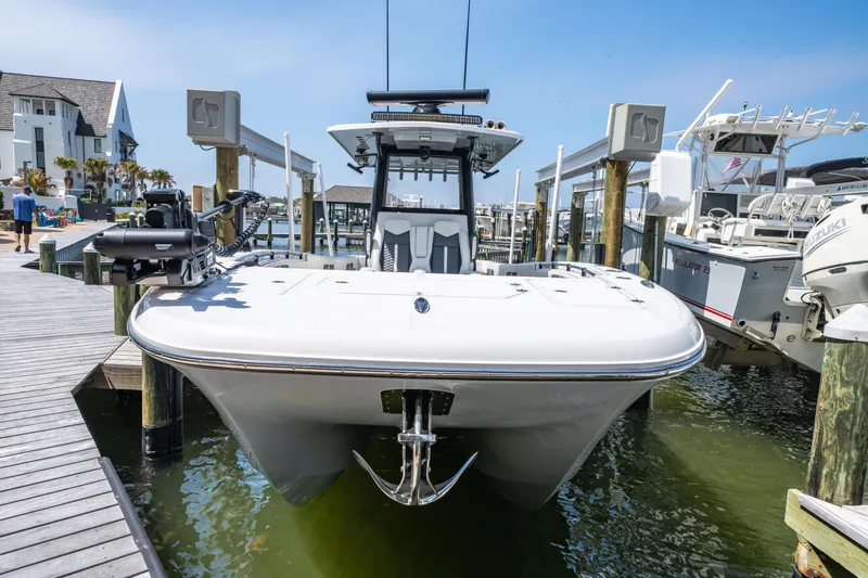 Slide: The Image of 2024 Invincible 33 Catamaran docked at marina, showcasing sleek design and modern features. - 43