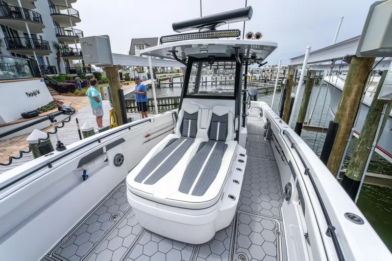 Slide: The Image of 2024 Invincible 33 Catamaran docked, showcasing sleek design and spacious deck layout. - 9