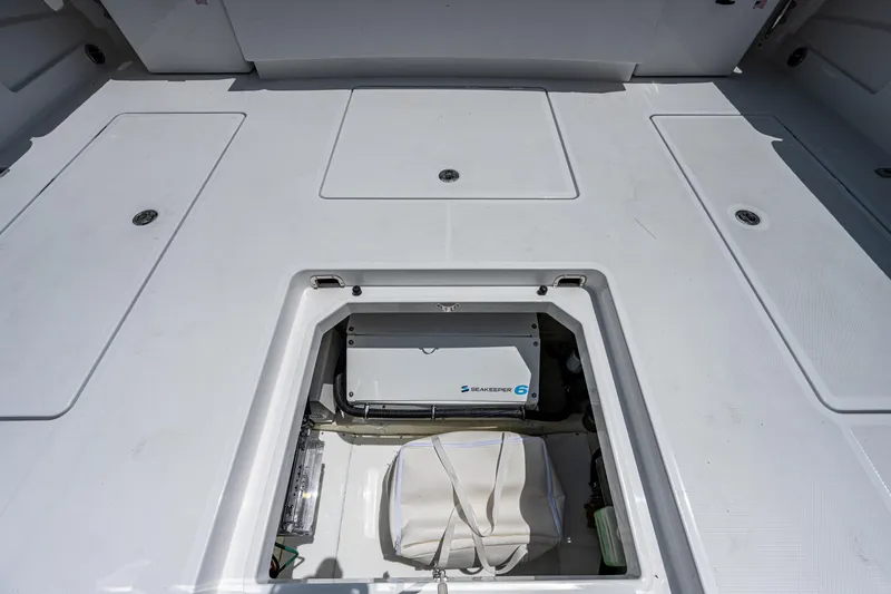 Slide: The Image of 2023 HCB 53 Sueños boat storage compartment with open hatch, showcasing interior equipment. - 15