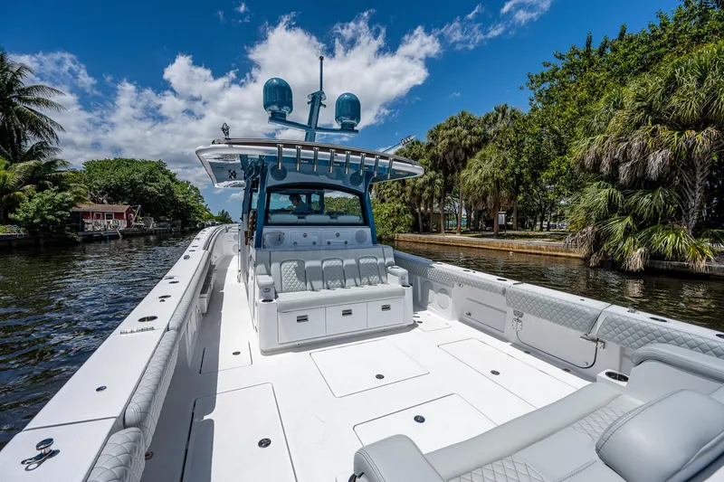 Slide: The Image of 2023 HCB 53 Sueños luxury boat on a scenic waterway, featuring spacious seating and modern design. - 17