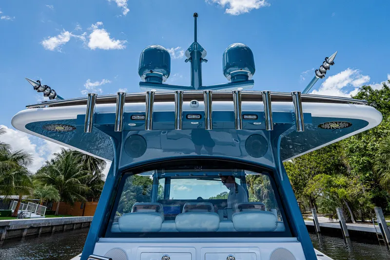 Slide: The Image of 2023 HCB 53 Sueños boat with advanced radar, docked under a clear blue sky. - 20