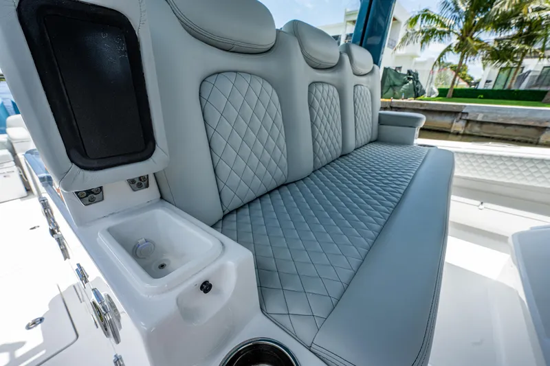 Slide: The Image of Luxurious seating on 2023 HCB 53 Sueños boat with quilted upholstery and cup holders. - 24
