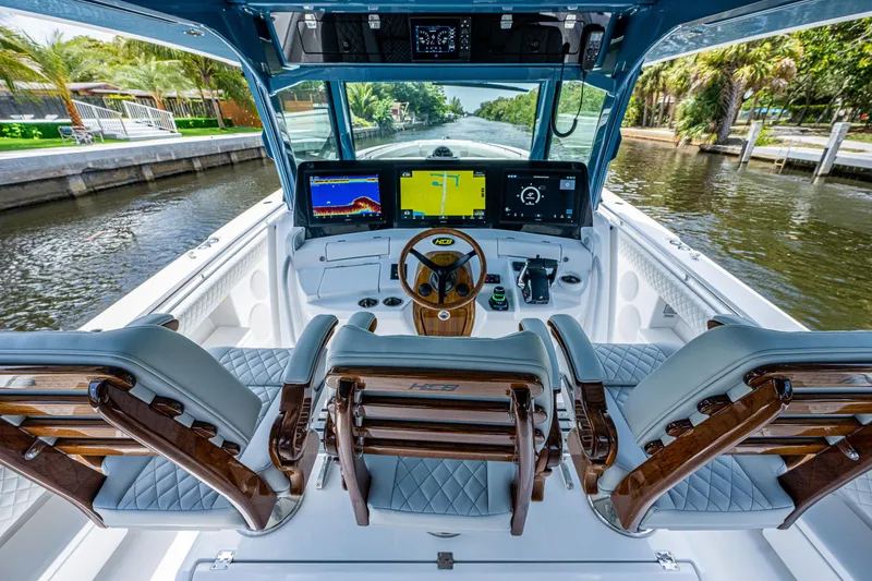 Slide: The Image of Helm of 2023 HCB 53 Sueños boat with advanced navigation displays and luxurious seating. - 25