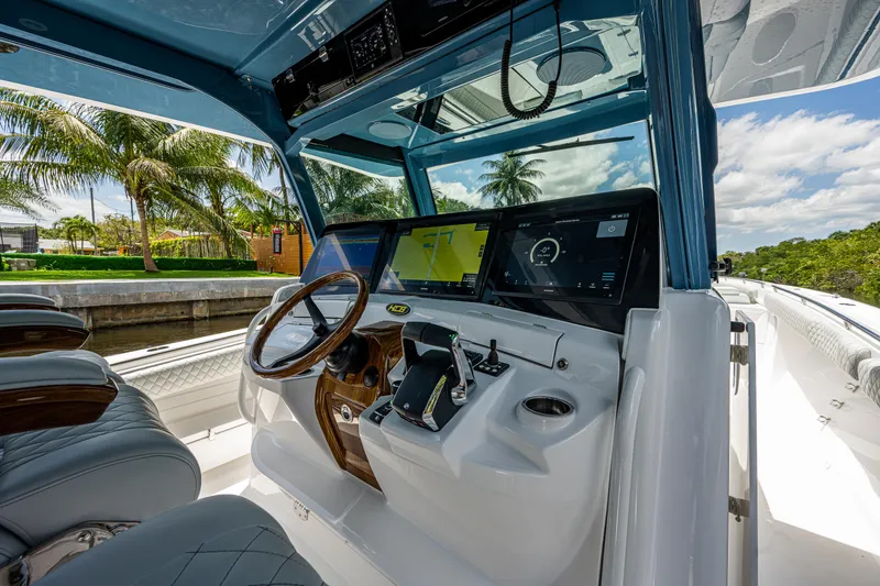 Slide: The Image of 2023 HCB 53 Sueños boat cockpit with modern controls and luxurious seating. - 26