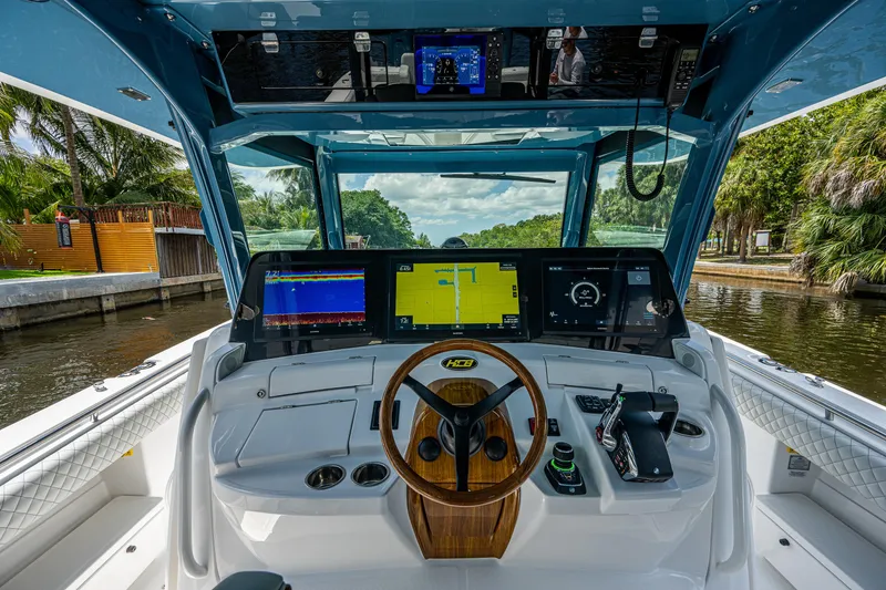 Slide: The Image of 2023 HCB 53 Sueños boat cockpit with advanced navigation displays and controls. - 28