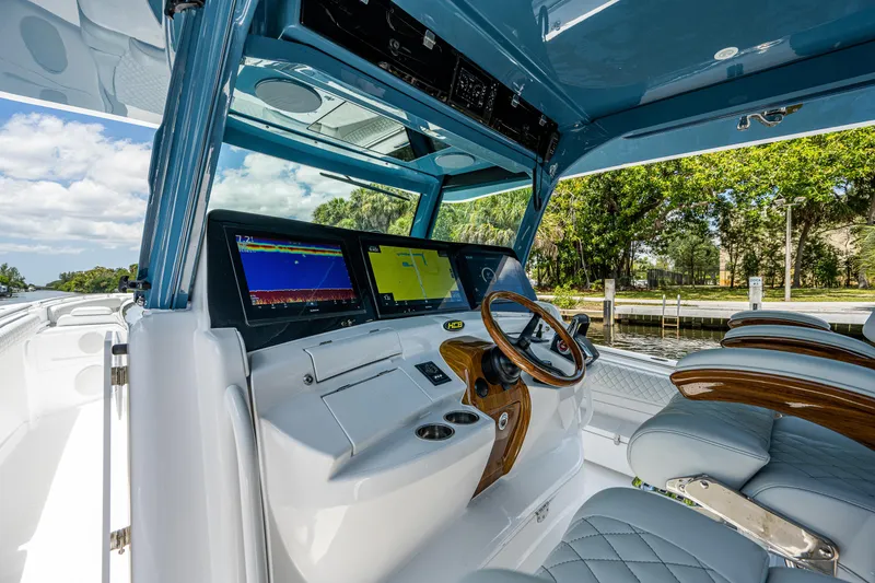 Slide: The Image of 2023 HCB 53 Sueños boat cockpit with advanced navigation screens and luxurious seating. - 29