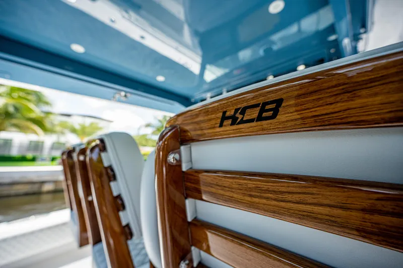 Slide: The Image of 2023 HCB 53 Sueños boat interior with wooden and leather seating. - 30