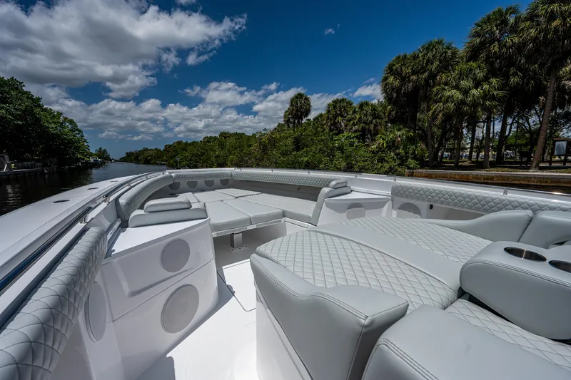Slide: The Image of 2023 HCB 53 Sueños luxury boat interior with plush seating and scenic waterway view. - 32