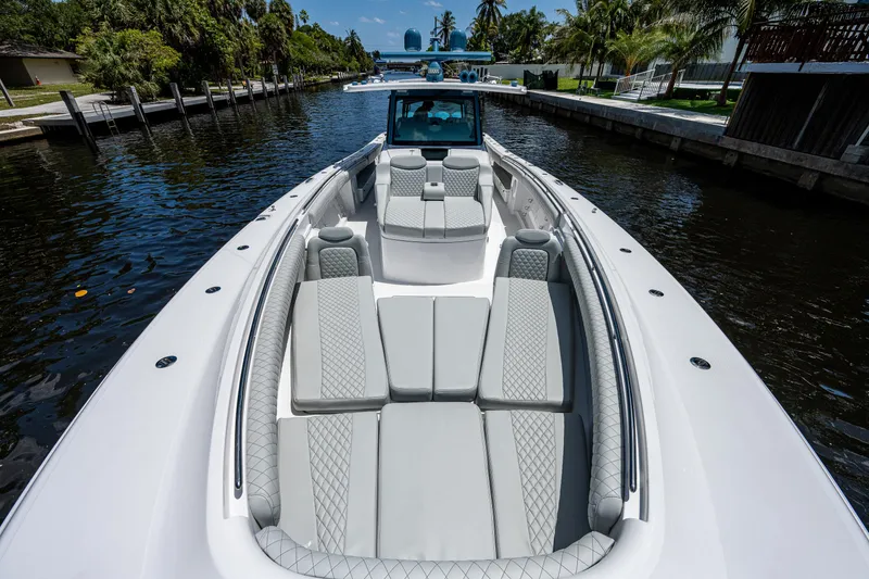 Slide: The Image of 2023 HCB 53 Sueños luxury boat with spacious seating on a serene waterway. - 35