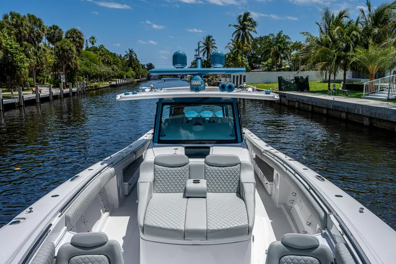 Slide: The Image of 2023 HCB 53 Sueños luxury boat on a scenic waterway with palm trees. - 36