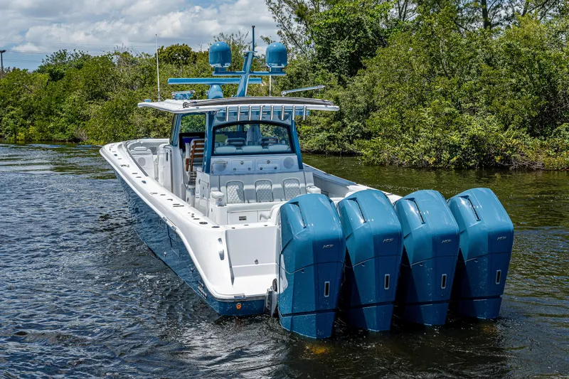 Slide: The Image of 2023 HCB 53 Sueños boat with four powerful engines on a scenic waterway. - 4