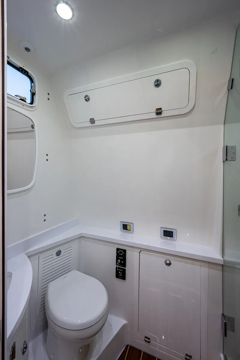 Slide: The Image of 2023 HCB 53 Sueños boat bathroom with modern fixtures and white interior design. - 48