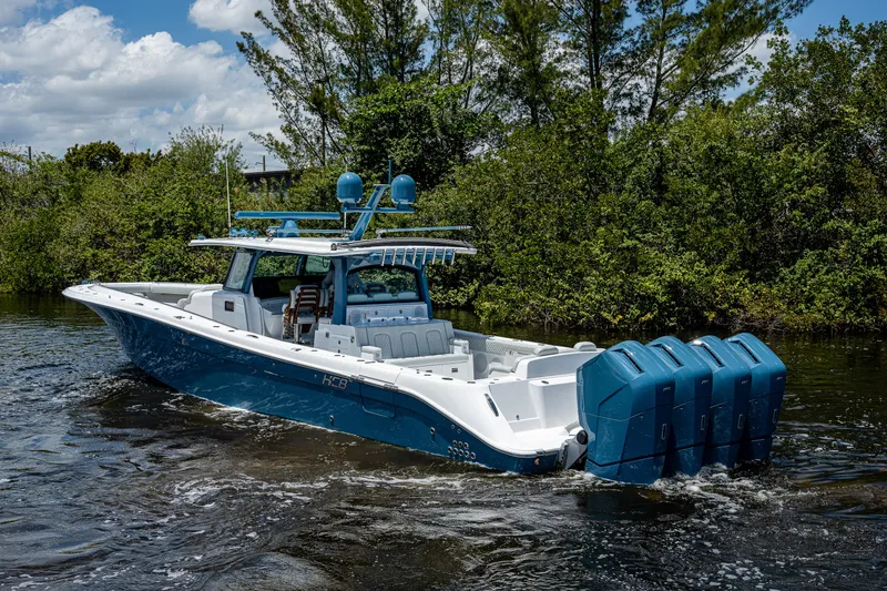 Slide: The Image of 2023 HCB 53 Sueños boat with multiple engines cruising on a river. - 5