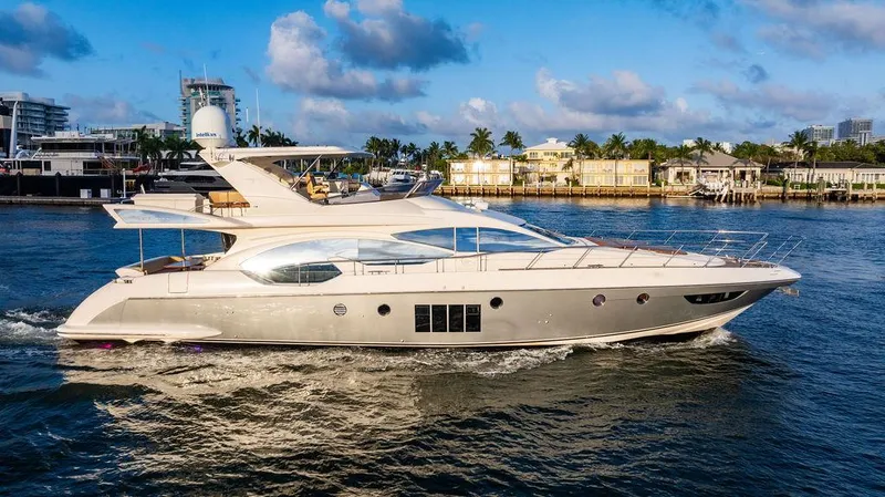Slide: The Image of Luxury 2011 Azimut 70 Fly yacht cruising on a sunny day near a marina. - 0