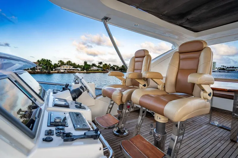 Slide: The Image of Luxurious helm of 2011 Azimut 70 Fly yacht with leather seats and control panel. - 1