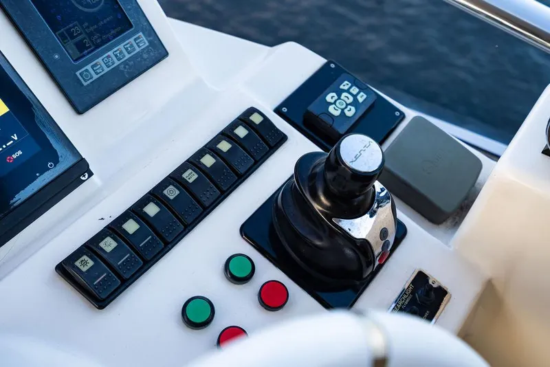 Slide: The Image of Control panel of a 2011 Azimut 70 Fly yacht with joystick and buttons. - 20