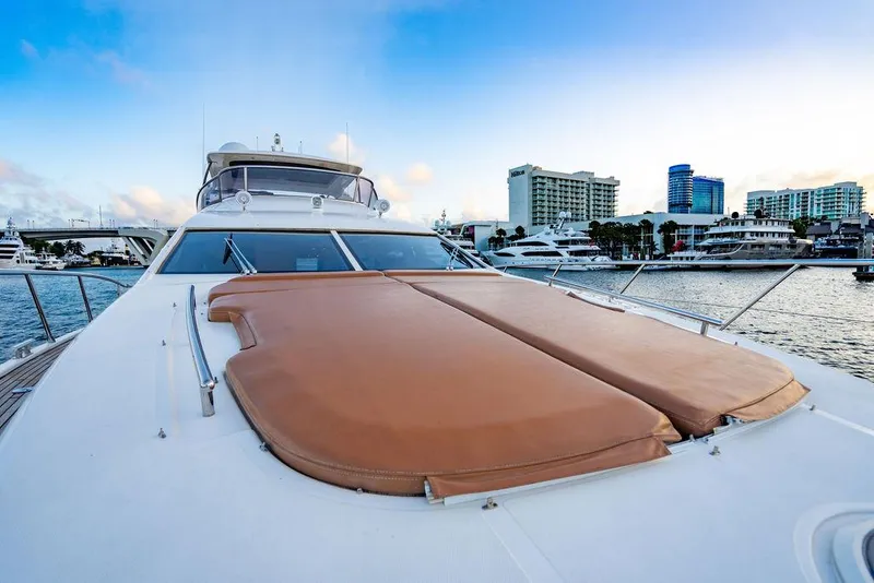 Slide: The Image of Azimut 70 Fly 2011 yacht with sunpads, docked near city skyline. - 23