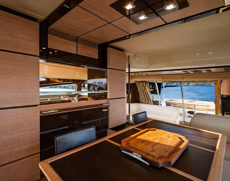 Slide: The Image of Luxurious interior of 2011 Azimut 70 Fly yacht with elegant wood finishes and dining area. - 30