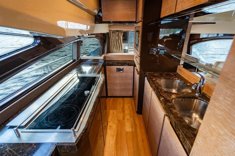 Slide: The Image of Luxurious kitchen interior of 2011 Azimut 70 Fly yacht with modern appliances and wood finishes. - 32