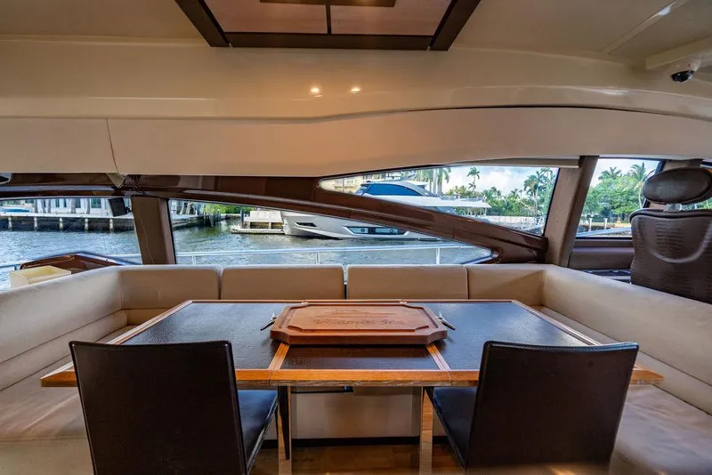 Slide: The Image of Interior view of 2011 Azimut 70 Fly yacht, featuring elegant dining area with waterfront backdrop. - 36