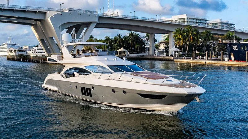 Slide: The Image of Azimut 70 Fly 2011 yacht cruising under a bridge in a tropical setting. - 4