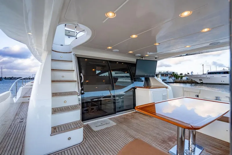 Slide: The Image of Luxurious 2011 Azimut 70 Fly yacht deck with seating, table, and staircase. - 6
