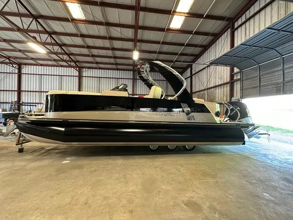 The Image of 2023 Starcraft SX 23 Q DC boat in a warehouse, side view. - 1