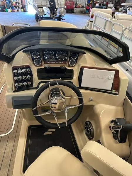 Slide: The Image of 2023 Starcraft SX 23 Q DC boat dashboard with steering wheel and control panel. - 11