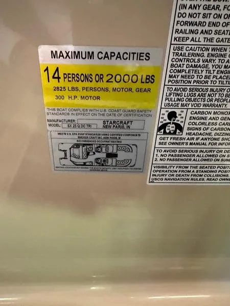 Slide: The Image of Capacity label for 2023 Starcraft SX 23 Q DC: 14 persons or 2000 lbs, 300 HP motor. - 12