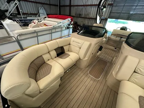 Slide: The Image of 2023 Starcraft SX 23 Q DC boat interior with luxurious beige seating in a showroom. - 16