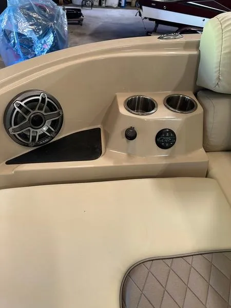 Slide: The Image of 2023 Starcraft SX 23 Q DC boat interior with speaker and cup holders. - 6