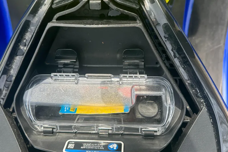 Slide: The Image of 2021 Sea-Doo Wake Pro 230 storage compartment with clear cover and visible contents. - 12