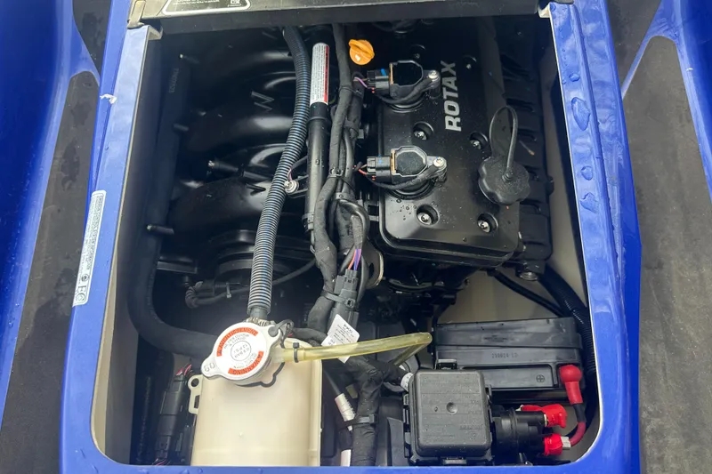 Slide: The Image of Engine compartment of 2021 Sea-Doo Wake Pro 230, featuring Rotax engine components. - 18