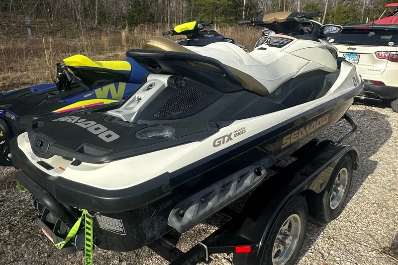 Slide: The Image of 2021 Sea-Doo Wake Pro 230 jet ski on trailer, parked outdoors. - 21